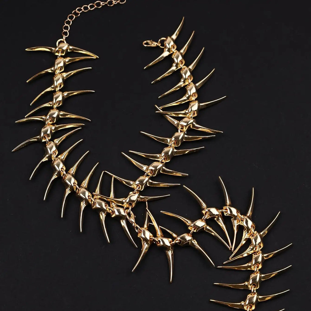 Back necklace with skeleton and skull pendant gold