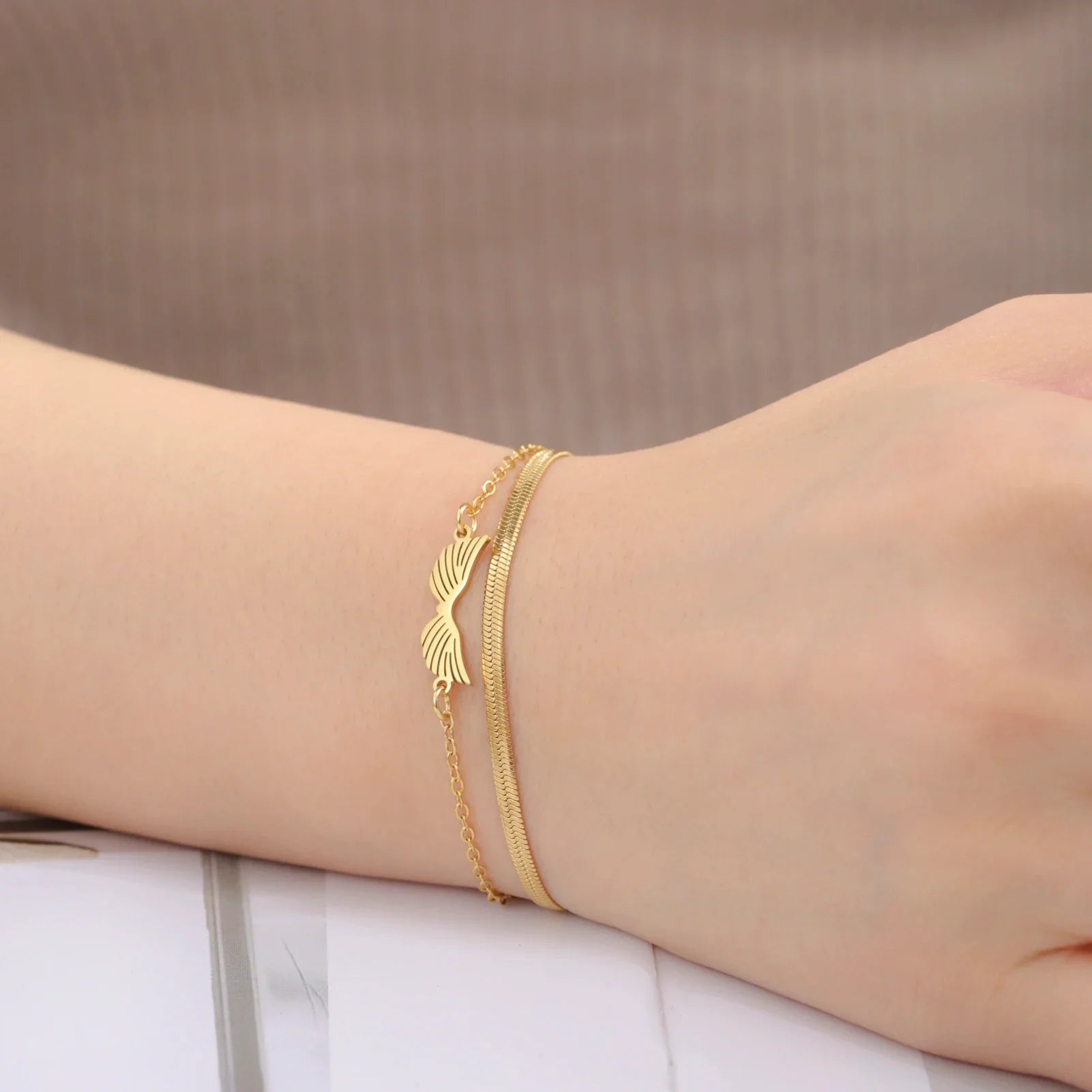 Pulsera doble alas de ángel oro