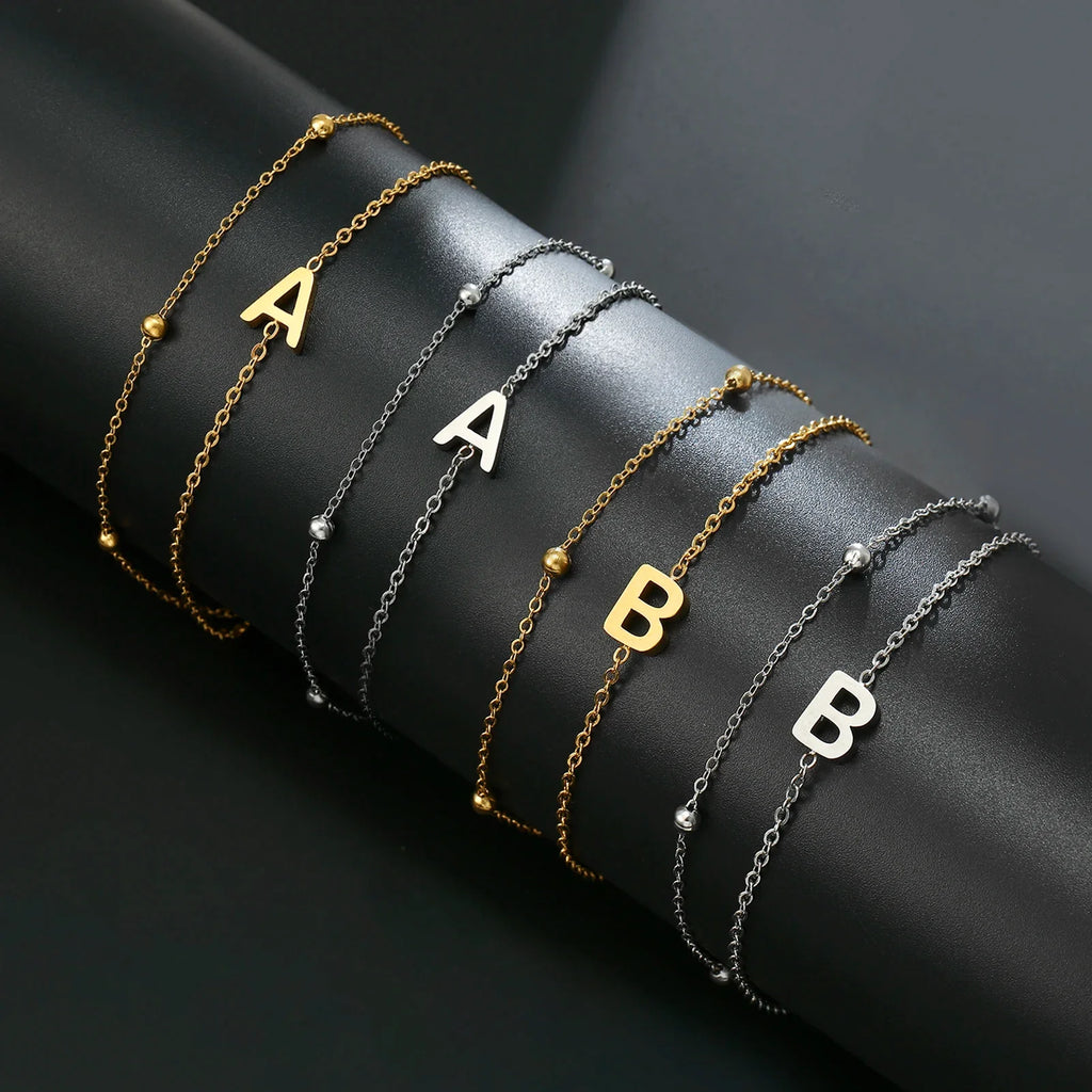 Pulsera de doble inicial oro y plata