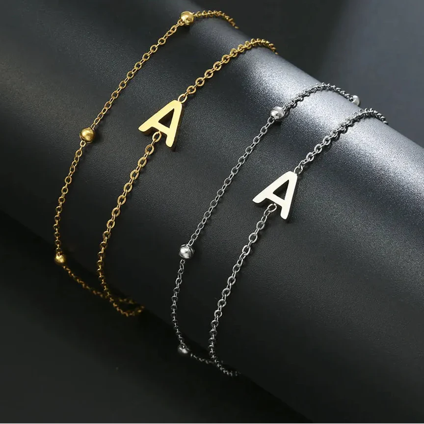 Pulsera de doble inicial oro y plata a