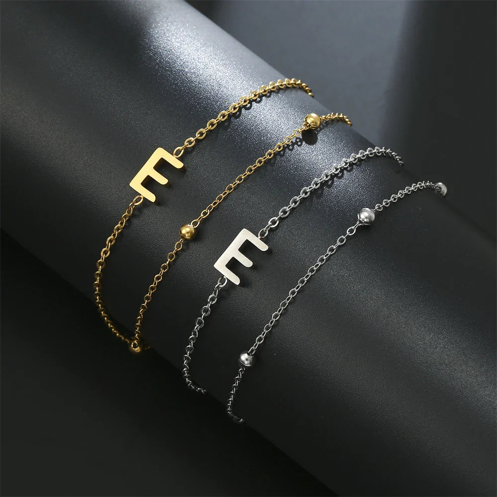 Pulsera de doble inicial oro y plata  e