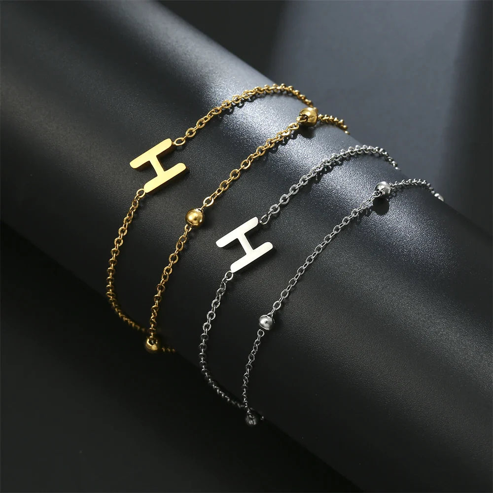 Pulsera de doble inicial oro y plata  h