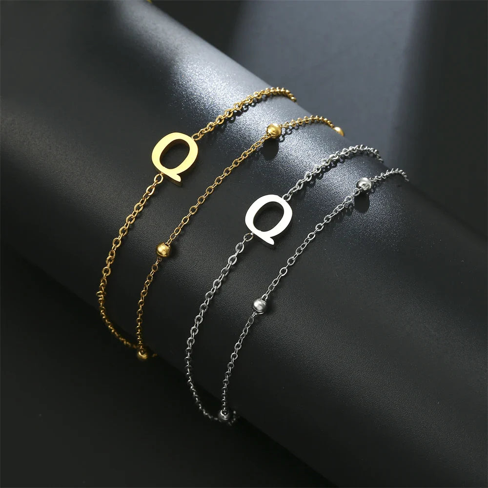 Pulsera de doble inicial oro y plata  q