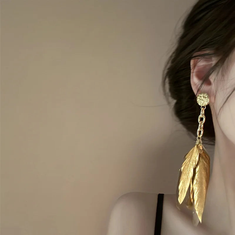 Pendientes grandes con plumas doradas