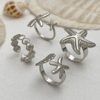 Lote de 4 anillos de conchas y estrellas de mar plateados