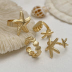Lote de 4 anillos de conchas y estrellas de mar dorados
