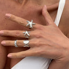 Lote de 4 anillos de conchas y estrellas de mar plateados