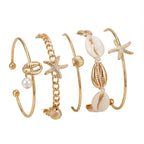 Lote de 5 pulseras con conchas y estrellas doradas