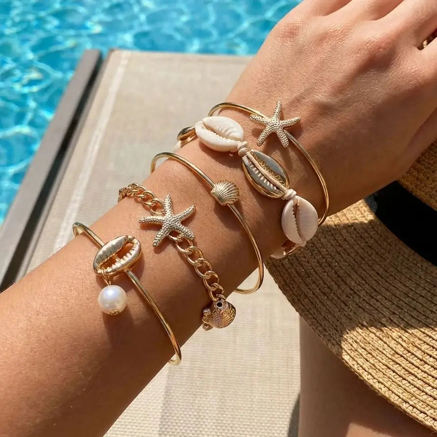 Lote de 5 pulseras con conchas y estrellas doradas